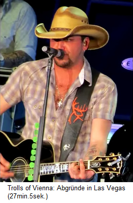 S�nger und Pseudo-Christ Jason Aldean mit einem Symbol halb Hirschgewei halb Horus-auge auf seinem Gitarrenriemen