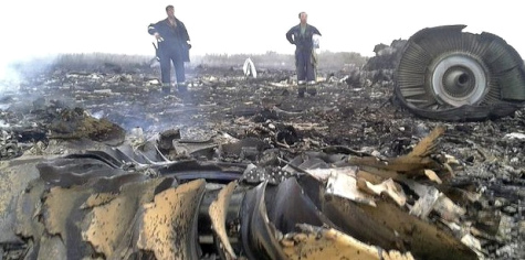 Crash
                        site of flight MH17 of July 17, 2014: Engines
                        with adult men aside