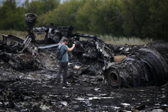 Crash site of flight MH17 of July 17,
                        2014: Engines with adult men aside