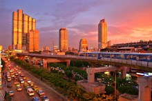 Bangkok with sky train and
                sky scrapers with the evening sky