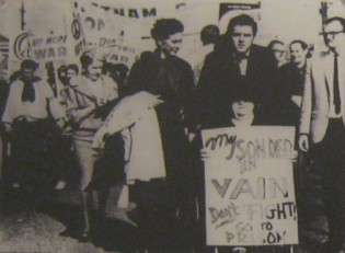 Demonstration gegen den Vietnamkrieg 1965 mit einer Rollstuhlfahrerin als Frontfrau: Am 20. November 1965 marschierten �ber 10.000 Menschen demonstrierend von Berkeley nach Oakland. In der vordersten Reihe war eine 84-j�hriege Frau im Rollstuhl mit einem Schild mit dem Aufruf: "Mein Sohn starb vergebens. H�rt auf zu k�mpfen, geht ins Gef�ngnis".