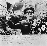 Gagarin en Praga: Gagarin con flores
                        moviendo una banderita checa y otra banderita
                        soviética