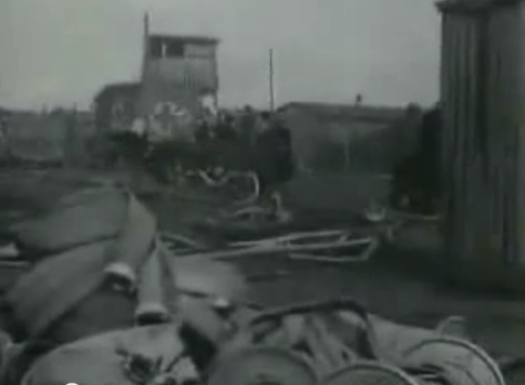 Water pipes and in the back ground a
                              car of the Red Cross can be seen (11min.
                              50sec.)