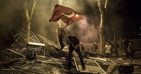 Trkische Schlgerpolizei
                          41, ein Demonstrant mit einer Trkei-Fahne auf
                          einem Schlachtfeld mit Gitter-Abschrankungen