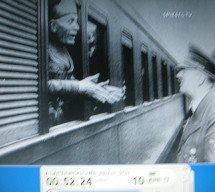 Wolfsschanze (Wolf's Lair)
                        03, Mussolini looking through the window of a
                        train, Hitler in front of it 01